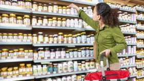 Customer choosing a dietary supplement at a pharmacy
